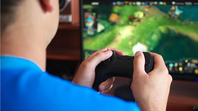 hand controller and video game on screen